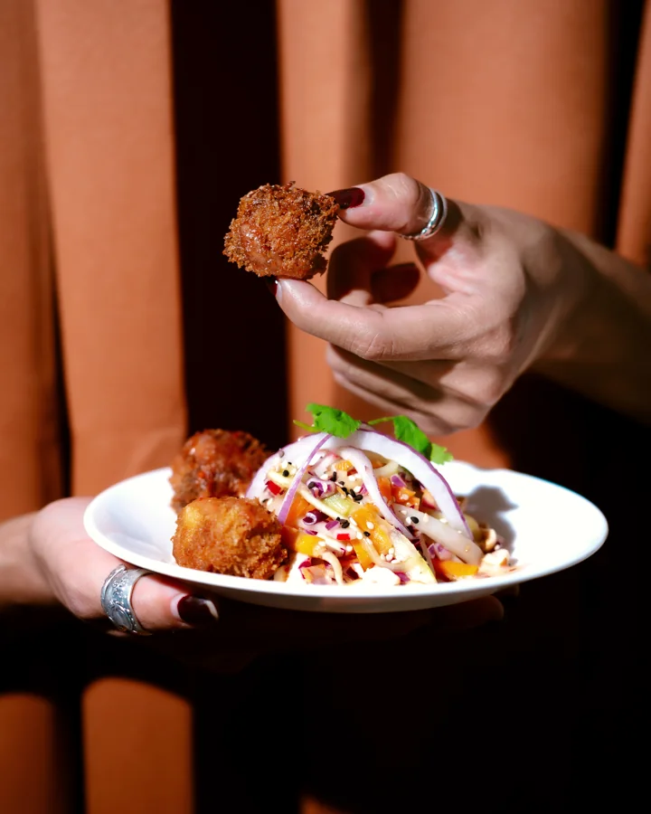 Hands share a starter at the center of the table.