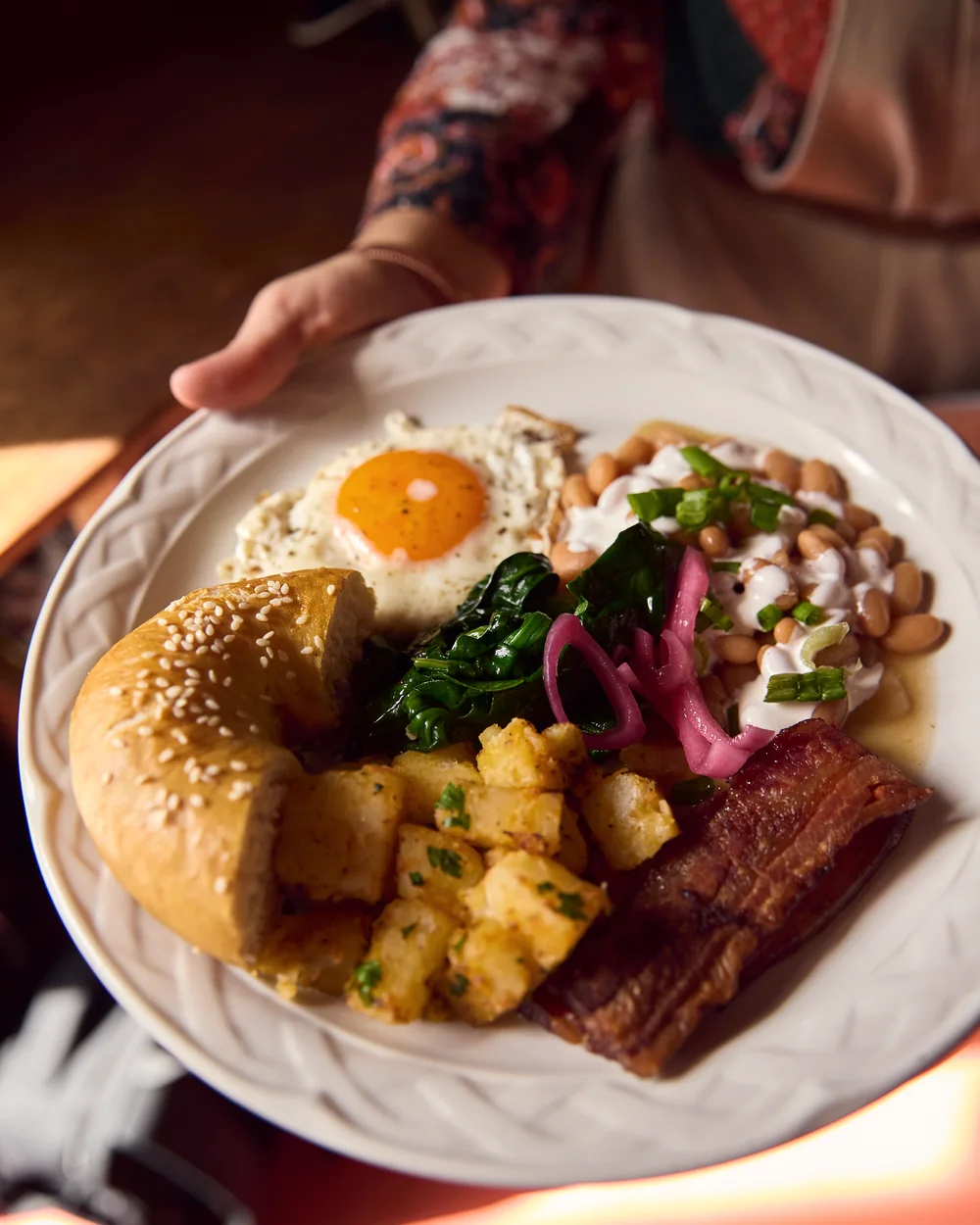Breakfast served with egg, bread, and sides.