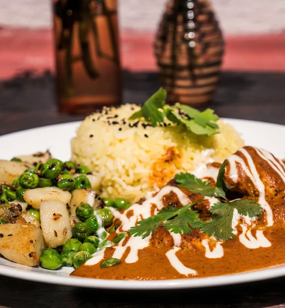 Curry served with rice and vegetables.